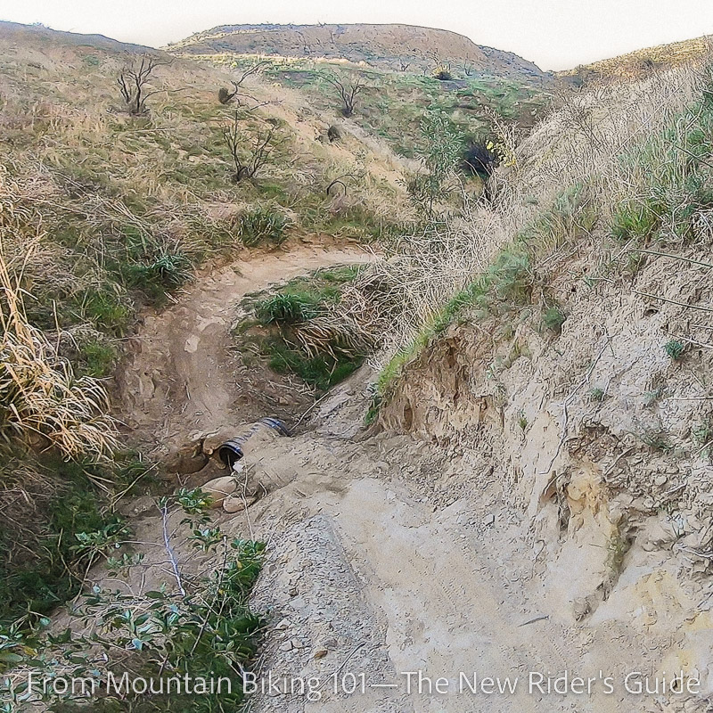 A deep dip in a single track trail on Tapia's G-Out