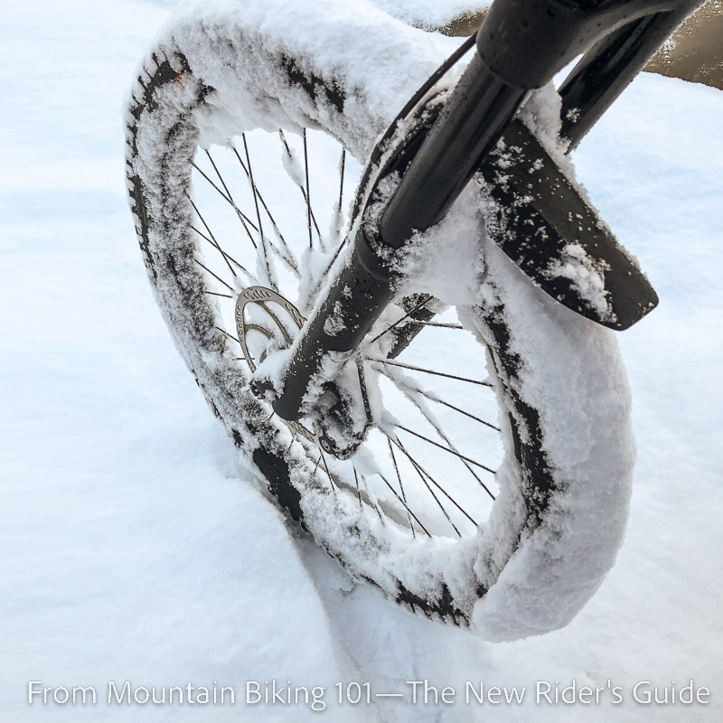 Sticky snow jamming a mountain bike wheel